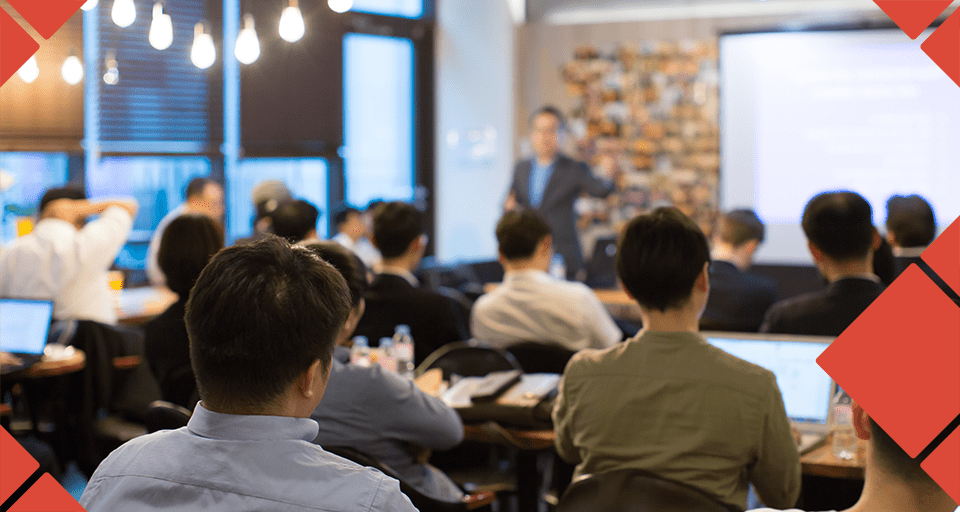 Healthcare professionals attending a group presentation, representing coordinated guidance and shared understanding around employee benefits.
