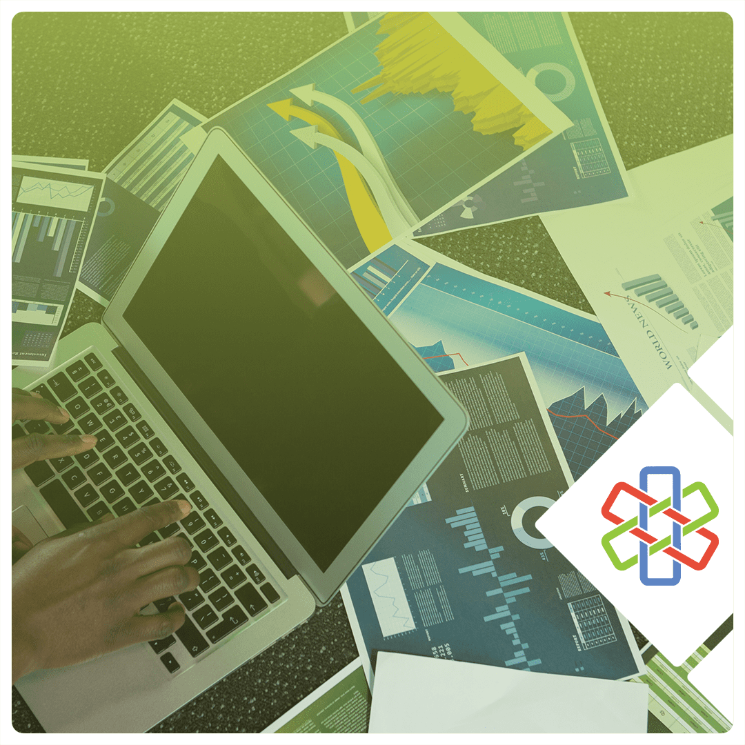 Professional reviewing insurance and financial documents on a laptop, representing the importance of mid-year coverage reviews for medical practices